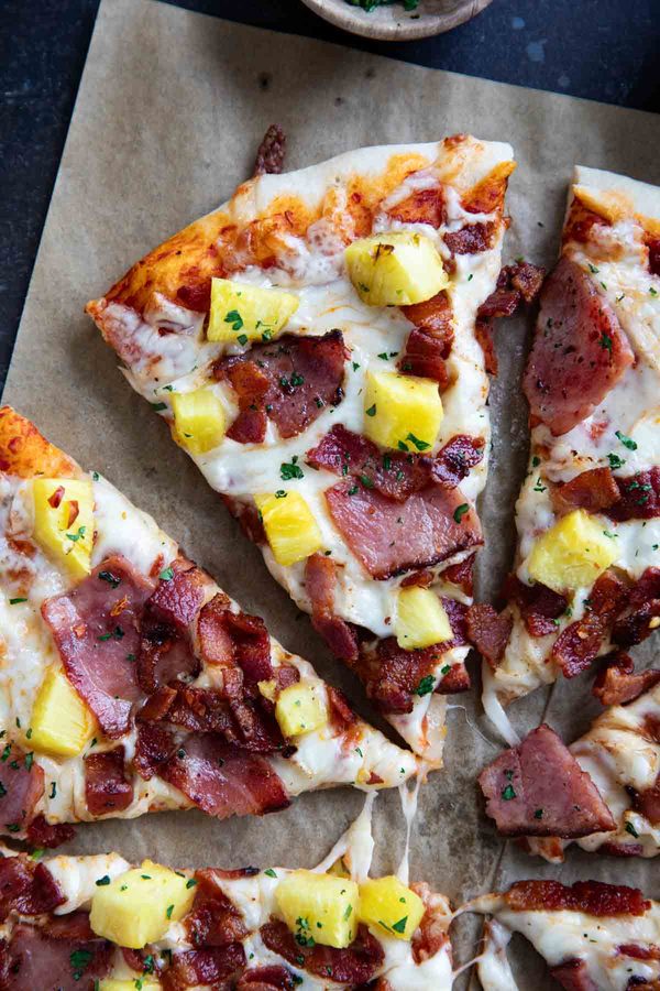 Hawaiian pizza slice with ham and pineapple